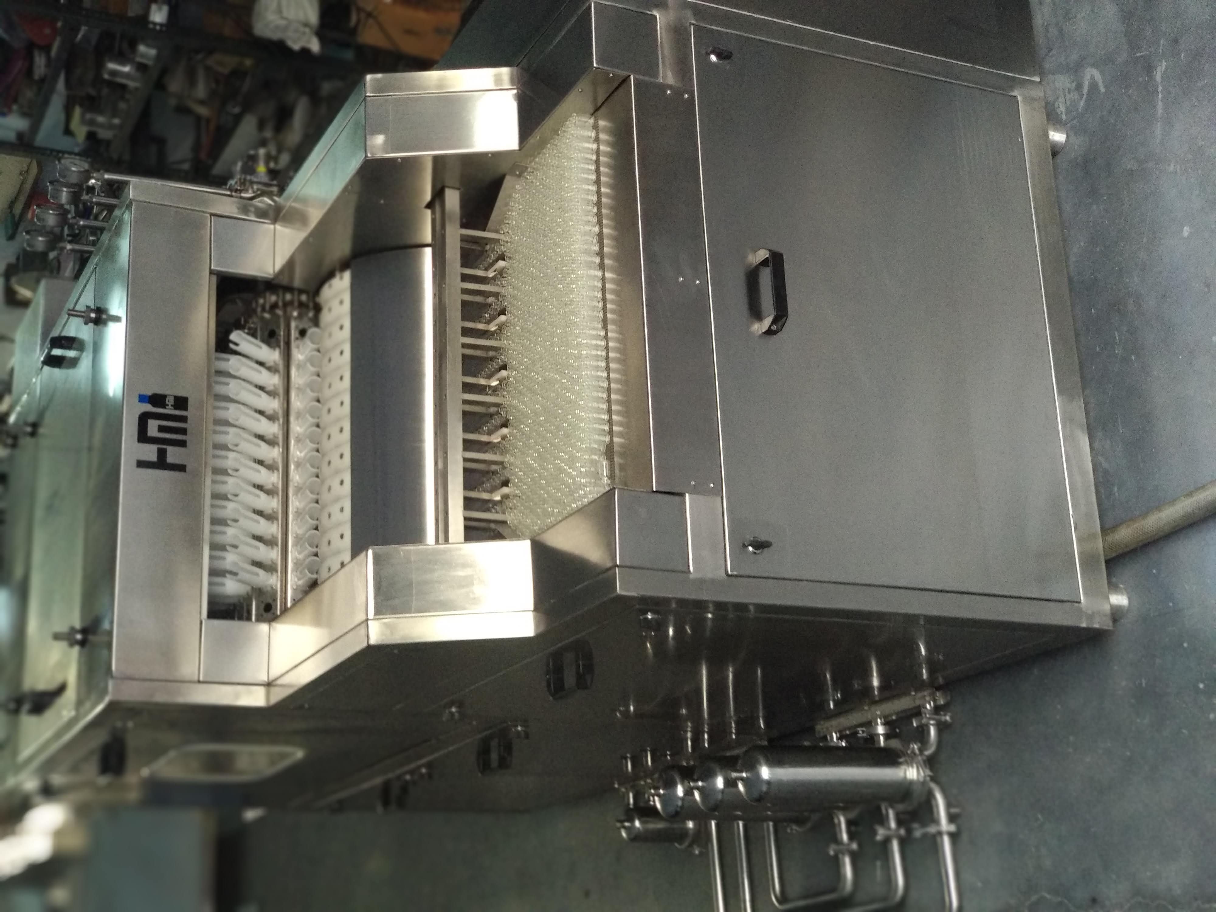 Linear tunnel type vial washing machine manufactured by H M Pharma Machines